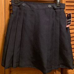 Navy Blue Uniform Approved Skirt With Pleated Bottom, Attached Boy Shorts, Elastic Waist, And And Decorative Buttons On The Front Waistband. Size 14. 100% Polyester. Nwt Fitted Pleated Skirt Bottoms For School, Fitted High Waist Bottoms For School, High Waist Fitted Bottoms For School, School Uniform Style Skirt, Fitted Tennis Skirt With Pockets For School, Lined Skirt Skort For School, Lined Skort For School, Short School Uniform Skirt, Preppy School Skirt Bottoms