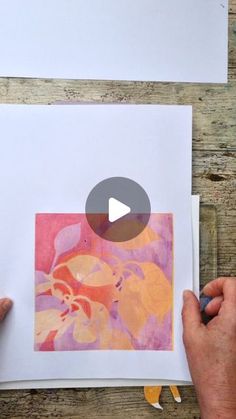 someone is making an art project with colored paper and watercolors on white paper