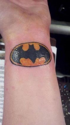 a wrist tattoo with a batman symbol painted on the inside of it's arm