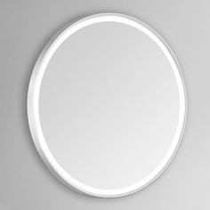 a white round mirror on the wall