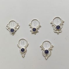 "These are soooooo pretty. Made is 925 sterling silver with tribal details, set with an alluring tanzanite stone. The rings are all 1cm (.40\") in diameter. The wire is 18 gauge. Each piece is made BY HAND so there may be very slight differences One of the images contains numbers to specify which you would like from the drop down menu." Bohemian Sterling Silver Body Jewelry As Gift, Spiritual Silver Body Jewelry For Gift, Bohemian Sterling Silver Body Jewelry Gift, Bohemian Sterling Silver Body Jewelry For Gift, Sterling Silver Body Jewelry As Gift, Celestial Sterling Silver Jewelry, Unique Sterling Silver Body Jewelry For Gifts, Sterling Silver Body Jewelry, Unique Sterling Silver Body Jewelry Gift