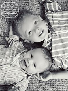 two little boys laying on the floor together