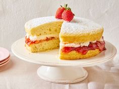 a strawberry short cake on a plate with a slice cut out