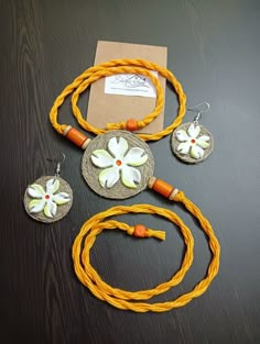 three necklaces and two earrings on a table