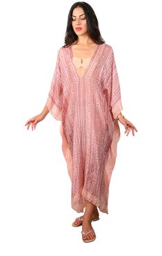 Our "3/4 Long V-Neck Kaftan" in our beautiful Silk Tabi quality is an easy but elegant kaftan to throw on and go. Great over swimwear or worn over a slip dress. The kaftan is a One Size fits all and can accommodate XS-2XL. Fabrication Content: 100% Silk Print Process: 100% hand block IKAT print, and every item is made by hand and a one of a kind item & limited items will be made in this style, Soft pink base with soft plum print. Size run: One Size Made in: Garment is custom made in LA - allow for 3 days in making plus transit time Care: Dry Clean Or rinse by hand in Luke warm water with small amount of detergent in the sink. The fabric is delicate so rise only, no rubbing. Hang on a hanger to dry and the item dries in 2 minutes. To see all the options filter : Beachwear" >>> "Kaftans" to Elegant V-neck Kaftan For Vacation, V-neck Kaftan For Resort Season, Flowy V-neck Tunic For Beach Cover-up, Summer V-neck Kaftan For Beach Cover-up, Spring V-neck Kaftan For Beachwear, Spring V-neck Beachwear Kaftan, Long Tunic For Beach Season, Unlined Beach Kaftan For Beachwear, Beachwear Unlined Kaftan For Beach