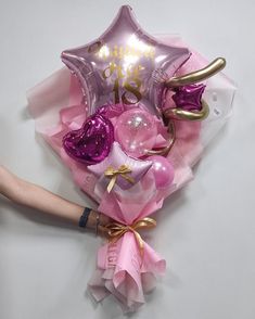 the balloon bouquet is pink and gold