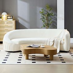 a modern living room with white furniture and black and white checkered rugs on the floor