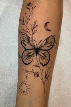 a black and white butterfly with flowers on the leg, next to a crescent moon