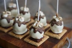 there are many desserts on the wooden tray