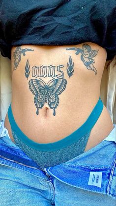 a woman with a butterfly tattoo on her stomach