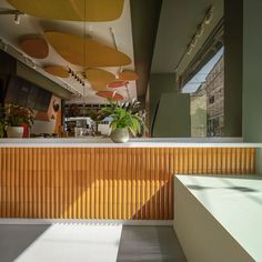 the interior of an office building with wooden slats on the wall and ceiling, as well as potted plants