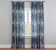 a window with blue curtains and wooden floors