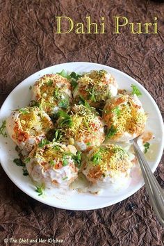 there is a white plate with food on it and the words dahi puri