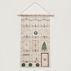 a white wall hanging with christmas decorations on it