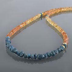 "Natural Imperial Topaz & Raw Rough Blue Diamond Handmade necklace Gemstone Color : Orange Blue Treatment : Natural Gemstone Size : 4-5MM Approx. Gemstone Shape : Rondelle Gemstone Finish : faceted Stone Beads : 44CM Silver Lock : 8MM Total Length Of Necklace: 47 Cm Can be Personalized : Yes Carat Weight : Approx. 80 carat Materials : 925 Sterling Silver Plating : Yellow Gold Plating, Rose Gold ,Silver Plating All of my jewelry is designed and handcrafted by me. I love to experiment with many different designs and although I may make similar designs more than once, each piece of jewelry is truly one of a kind due to variations between gemstones and within my own craft work. All my jewelry is carefully packed So it ready for gift giving, whether it is a gift for you or someone special. Trea Blue Diamond Necklace, Raw Diamond Necklace, Rough Diamond Jewelry, Blue Diamond Jewelry, Watermelon Tourmaline Necklace, Black Diamond Bracelet, Crystal Stone Jewelry, Imperial Topaz, Stacked Necklaces