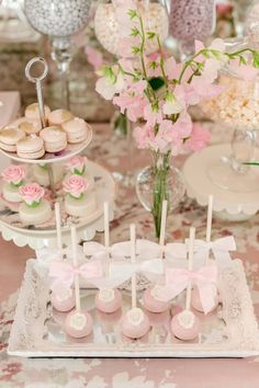 a table topped with lots of desserts and cupcakes on top of plates