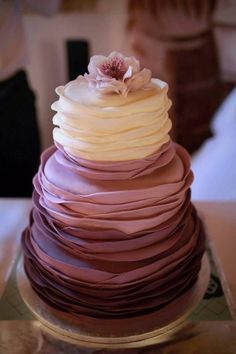 a multi layered cake sitting on top of a table