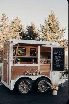 a food truck parked in front of some trees