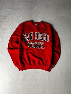 Vintage Champion San Diego State Crewneck Sweatshirt, Vintage Sweatshirt, Champion Sweatshirt Men's XS Size On Label: XS Recommended Size: Men's XS Measurements: Pit-to-Pit: 18" Length: 26" Collegiate Winter T-shirt For Streetwear, Streetwear Tops With Embroidered Logo, Embroidered Logo Tops For College Style Streetwear, College Crew Sweater With Logo Print, College Fan Apparel Sweatshirt With Logo Print, University Red Crew Neck Top For Streetwear, Winter College T-shirt With Logo Print, Collegiate Crew Sweatshirt With Logo Print, University Red Crew Neck Hoodie For Sports