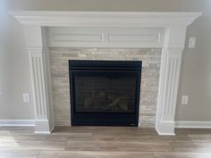 an empty fireplace in a living room with white trim