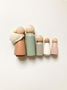 small wooden dolls lined up in a row