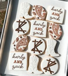 decorated cookies in the shape of letters and numbers on a white tray with brown lettering