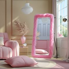 a living room with pink furniture and a large mirror on the wall above it's door