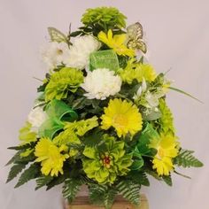 a vase filled with yellow and white flowers