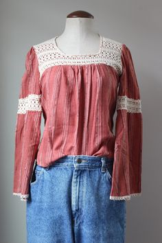 "Cutest vintage hippie blouse from the 70s! Intricate, hand crocheted lace - this would have taken a LONG time to make by hand. Slight bell sleeves and billowy empire waist. Cozy cotton blend fabric. 50% cotton, 50% polyester. Dark pink/red color. Label is faded, no brand or sizing legible. Estimated size S. Please see measurements for accurate fit. Measurements (taken laid flat, doubled where necessary): Length: 21\" Shoulders: 14\" Chest: 34\" Sleeve length: 22\" Condition: Excellent vintage c Fitted Cotton Lace Tops With Crochet Trim, Bohemian Cotton Lace Top With Patchwork, Bohemian Cotton Lace Top With Lace Patchwork, Bohemian Lace Top With Cotton Lace Patchwork, Bohemian Lace Top With Lace Patchwork, Bohemian Crochet Top With Crochet Trim For Fall, Vintage Tops With Lace Patchwork For Fall, Vintage Lace Patchwork Tops For Fall, Hippie Cotton Crochet Top With Lace Details