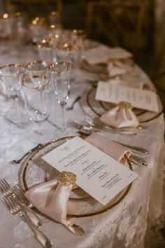 the table is set with silverware and place settings