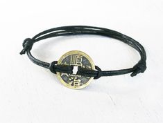 "This ancient Chinese coin bracelet is made of a ancient Chinese coin charm with double waxed cord. Some Chinese like to wear ancient Chinese coin jewelry or hang ancient Chinese coin ornament at home because they believe the ancient Chinese coin would bring good luck and fortune to their life. The ancient Chinese coin charm is made of brass. The size of coin is 24mm in diameter. There are two styles: Knot closure (picture 1) - The length of bracelet is adjustable. It can be adjusted to ±1 size. Traditional Adjustable Coin Jewelry, Nickel-free Coin-shaped Bracelets As Gifts, Chinese Bracelet, Luck Symbols, Chinese Coin, Bring Good Luck, Beaded Leather Bracelet, Good Luck Bracelet, Asian Jewelry