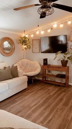 a living room filled with furniture and a flat screen tv mounted to the side of a wall