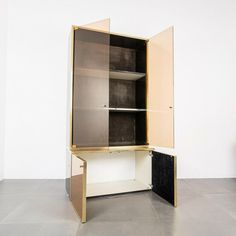 an open cabinet sitting in the middle of a room