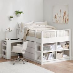 there is a white bed with a desk underneath it and bookshelves on the bottom shelf