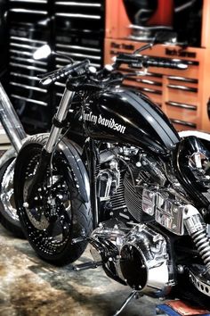 a shiny black motorcycle parked in a garage