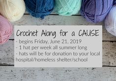 crochet along for a cause sign next to balls of yarn