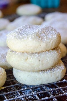 some sugar cookies are stacked on top of each other in the middle of cooling racks