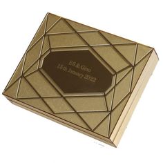 a gold and brown wedding guest book with a diamond design on the front cover,