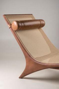 a wooden chair with a leather cushion on it