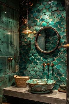 a bathroom with green tiles and a round mirror on the wall, along with a vessel sink