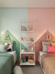 two beds in a room with pink and green walls, one has a book shelf next to the bed