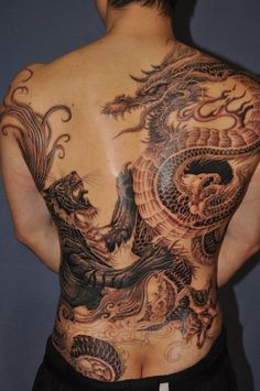 a man with a dragon tattoo on his back