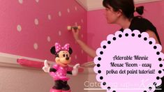 a woman is painting the walls in her pink minnie mouse room with polka dot paint