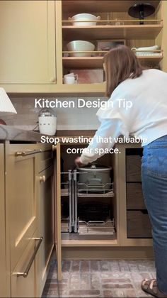 a woman is opening the oven door to look at something on the counter in the kitchen