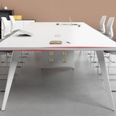 a white table with chairs around it in an office