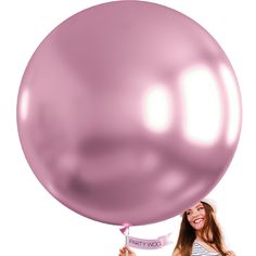 a woman holding onto a large pink balloon