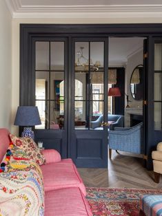 a living room filled with furniture and lots of windows