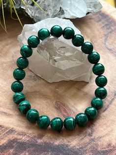 "ONE Natural 8mm Malachite Bead Bracelet Extra Small - 6.5\" Fits wrists measuring 5.5\" to 6\" Small - 7\" Fits Fits wrists measuring 6\" to 6.5\" Medium - 7.5\" Fits wrists measuring 6.5-7\" Large - 8\" Fits wrists measuring 7\" to 7.5\" Extra Large - 8.5\" Fits wrists measuring 7.5\" to 8\"" Handmade Malachite Beaded Bracelets For Spiritual Use, Handmade Malachite Spiritual Beaded Bracelets, Green Malachite Beaded Bracelets, Green Malachite Spiritual Beaded Bracelets, Spiritual Green Malachite Beaded Bracelets, Malachite Jewelry With 8mm Round Beads, Spiritual Malachite Beaded Bracelets With Gemstone Beads, Handmade Malachite Bracelets With Round Beads, Spiritual Malachite Beaded Bracelets For Healing