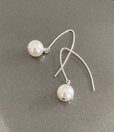 "Large white Swarovski crystal pearl drop dangle arc earrings are available in gold filled or sterling silver. Lightweight, minimalist & modern. A great addition to any outfit dressed up or down, day to evening. They go with everything.  The earrings are appox 1.5\" from end to end.   You may also like to check out more of my pearl jewelry and June birthstone gift ideas here: https://etsy.me/3olEKFI You may also like to check out more of my earrings here: http://etsy.me/2oDJlWy Free first class USPS shipping within the USA." Pearl Dangle Earrings, Jewelry Words, June Birthstone, Pearl Earrings Dangle, Swarovski Pearls, Gold Earrings Dangle, June Birth Stone, Silver Earrings Dangle, Crystal Pearls