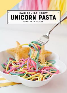 a white bowl filled with unicorn pasta and a fork sticking out of the top one